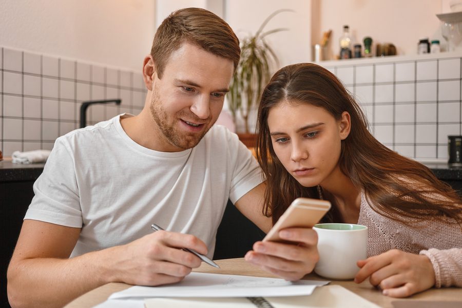 Couple reviewing a debt payoff plan on a shared tablet