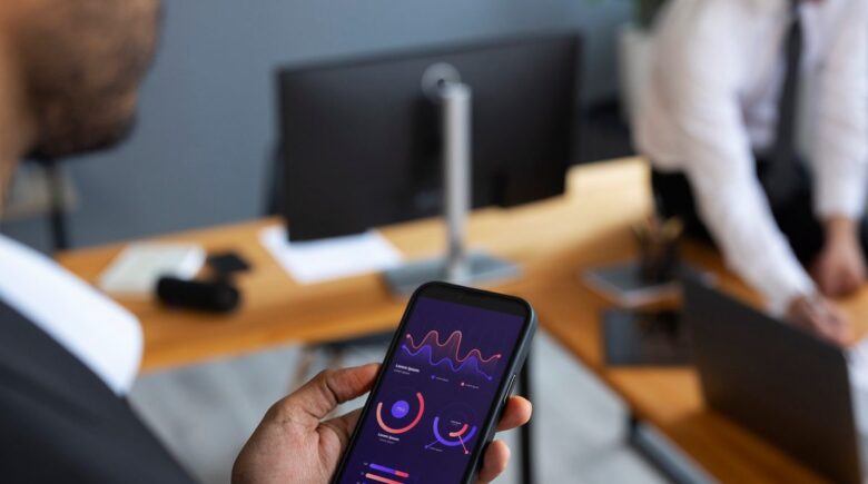 Smartphone displaying AI investment app dashboard next to printed financial plan document