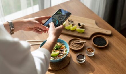 Comparison of a smartphone showing an AI meal planning app interface next to a printed static meal plan from a dietitian
